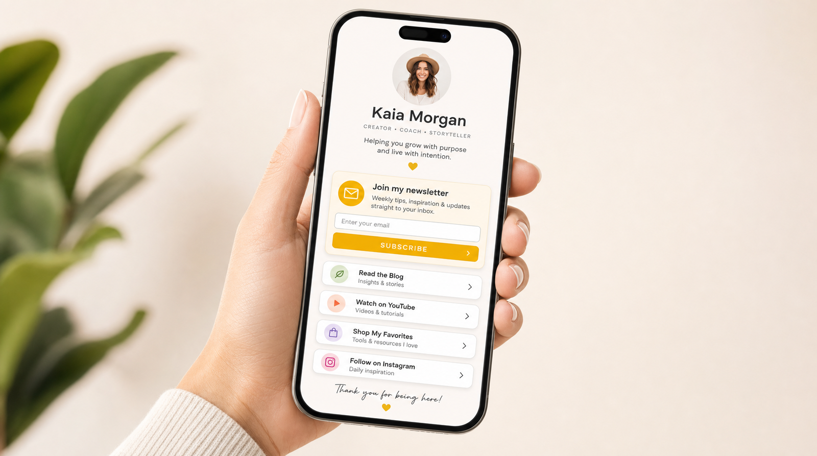 A smartphone displaying a clean link-in-bio page with a highlighted newsletter sign-up button and an email entry field near the top, held in one hand against a soft neutral background.